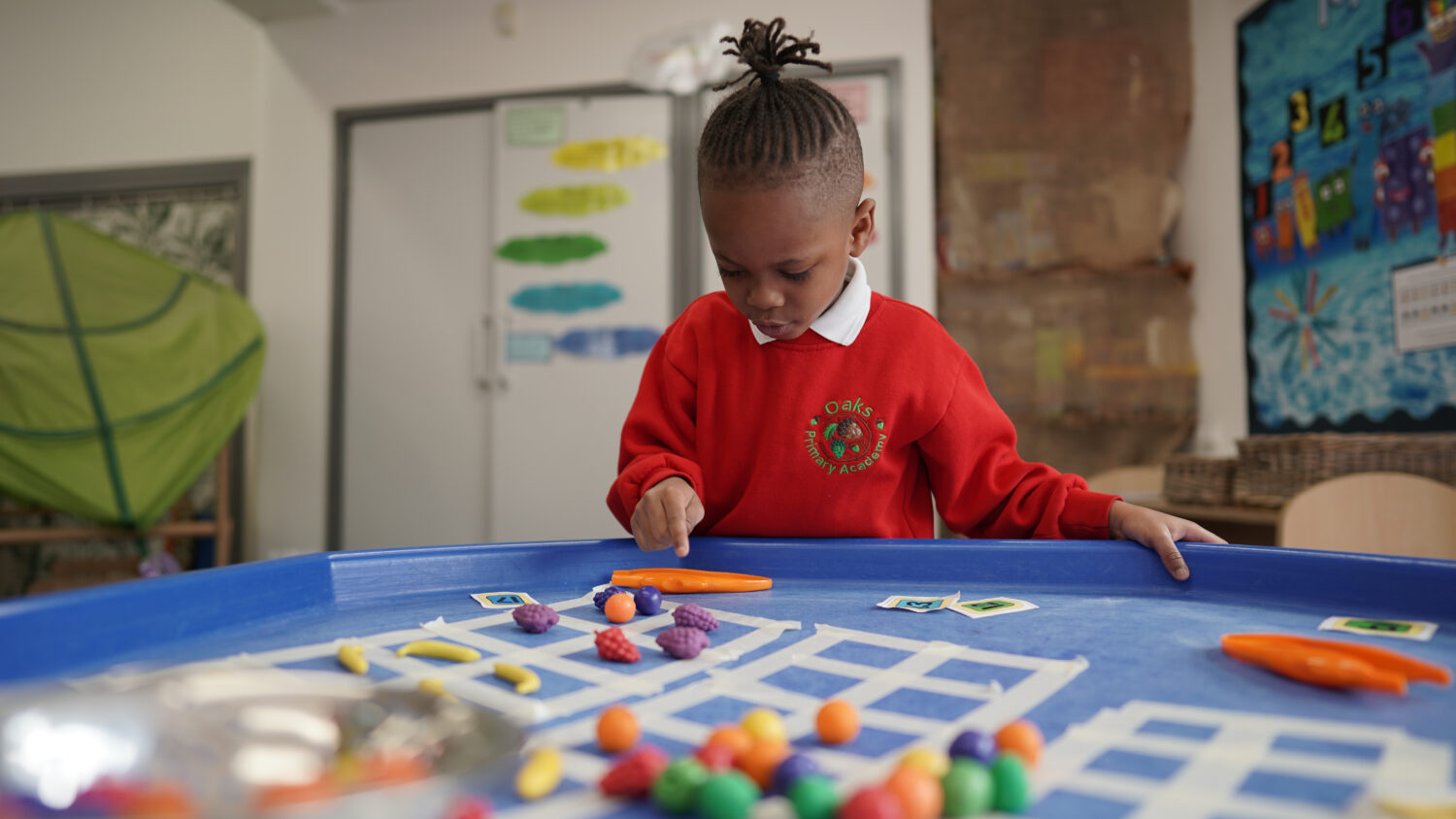 A student looking at toys on a table