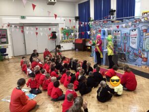 Students sat on the floor watching a show