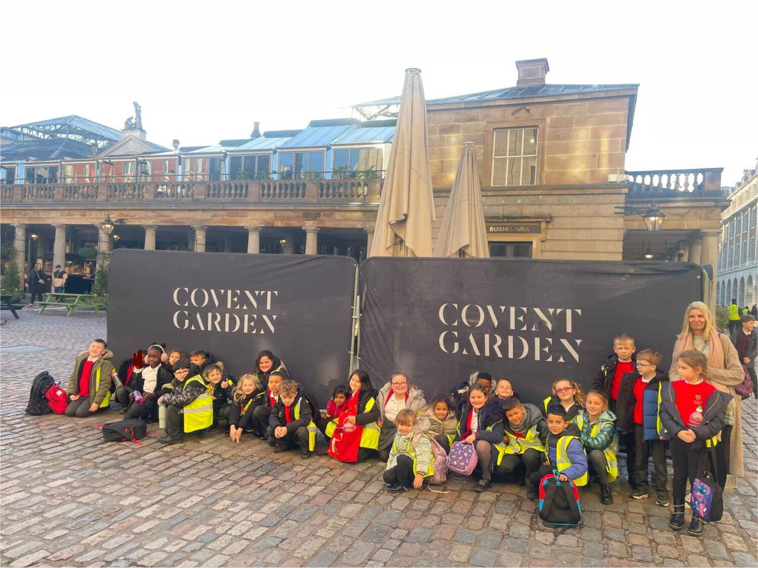 Students sat in front of banners reading 'Covent Garden'