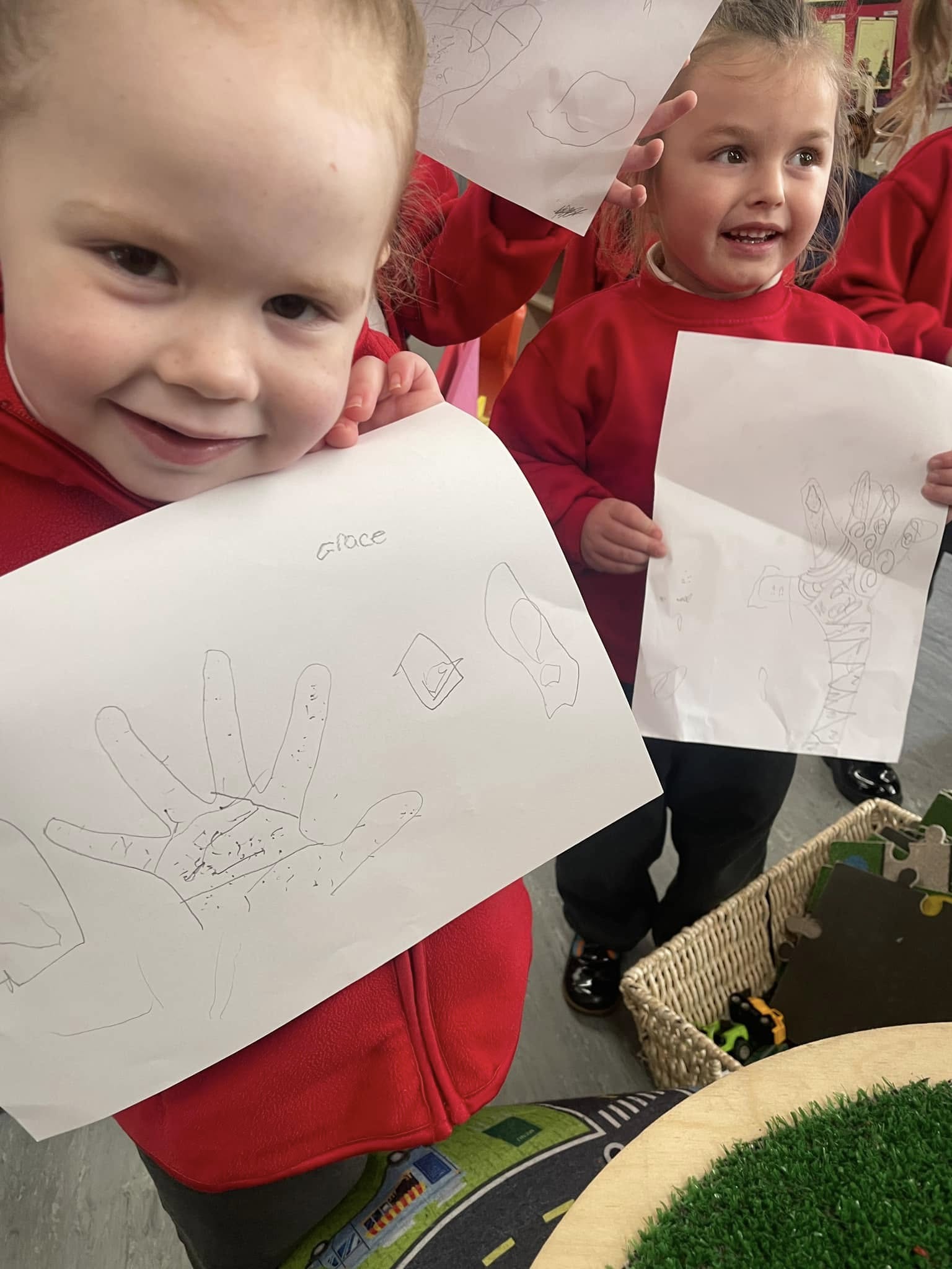 Children holding up their drawings