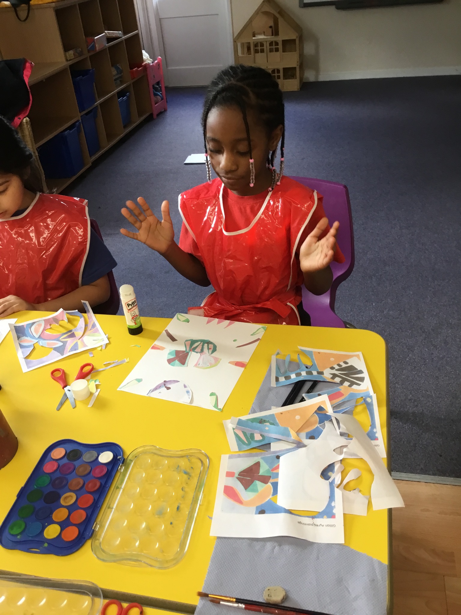 A child at a table looking at their work