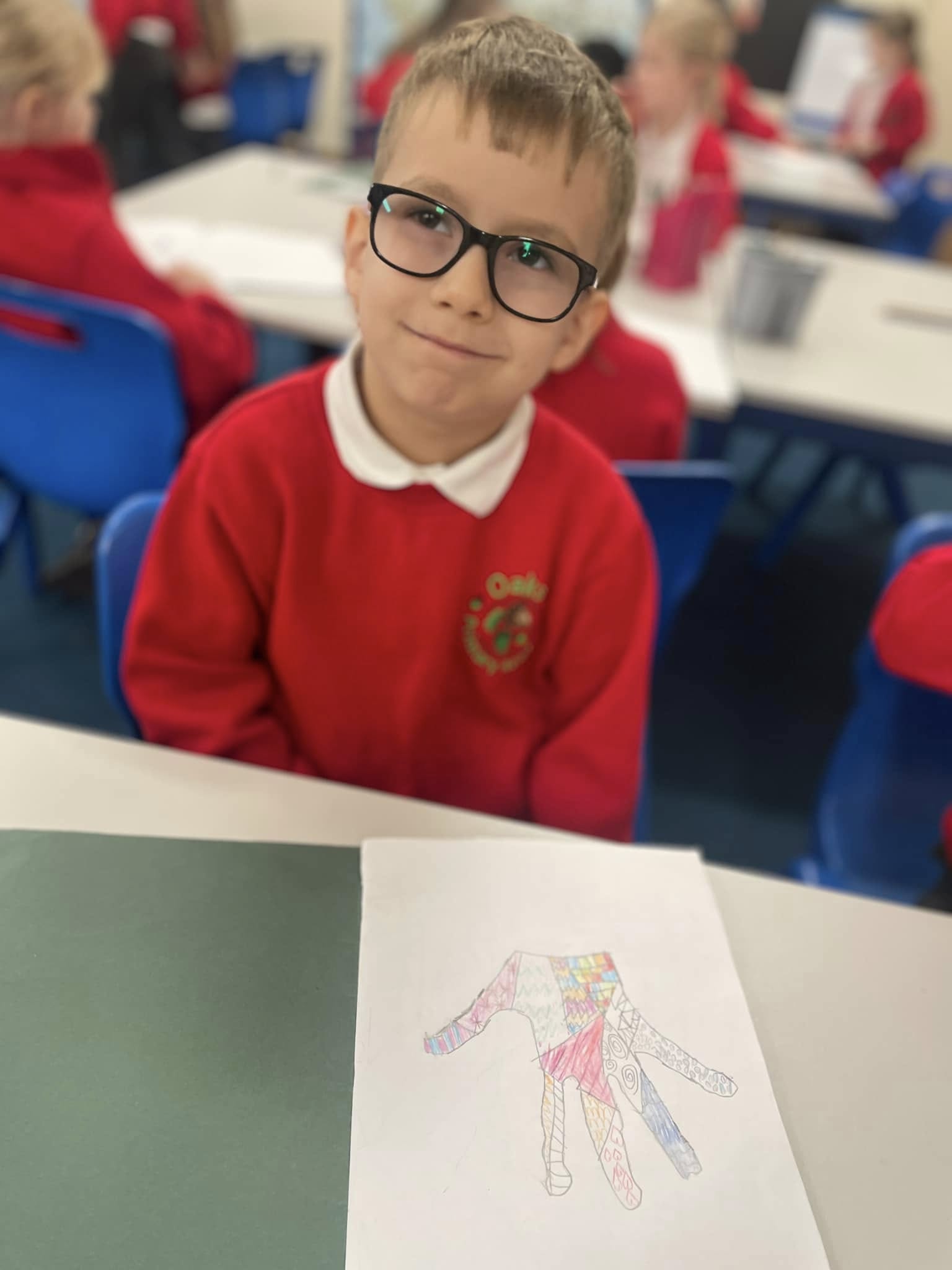 A child at a table, smiling