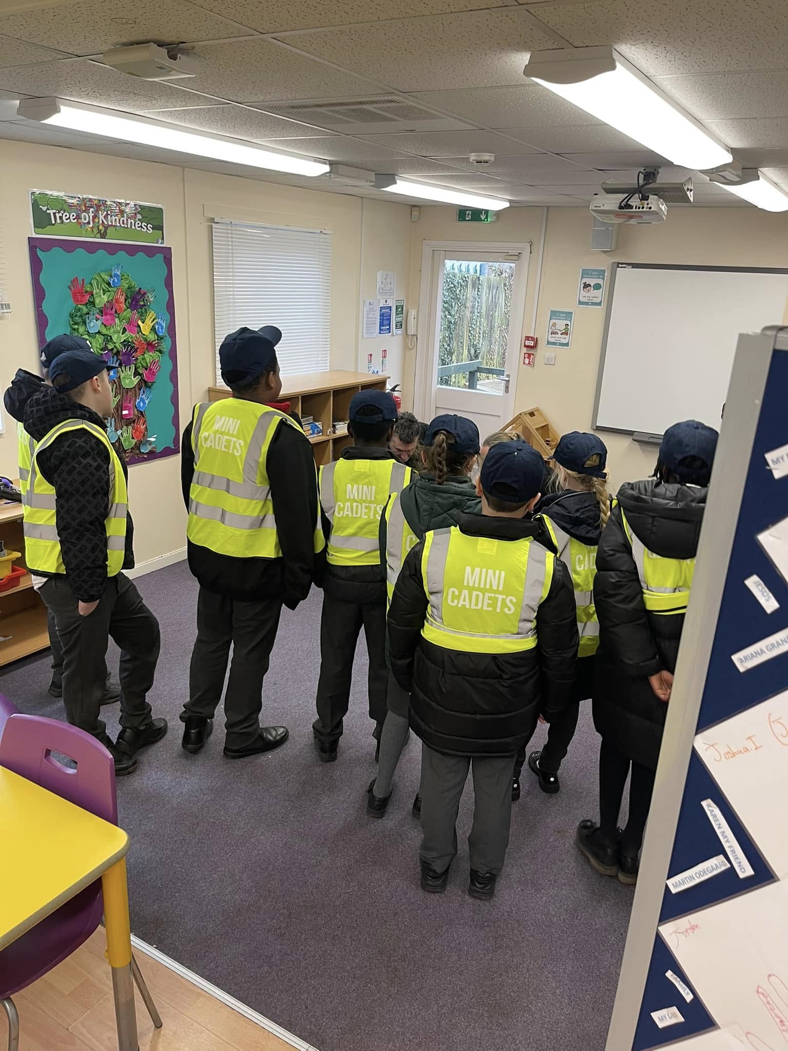 Students in hi-vis jackets in a classroom
