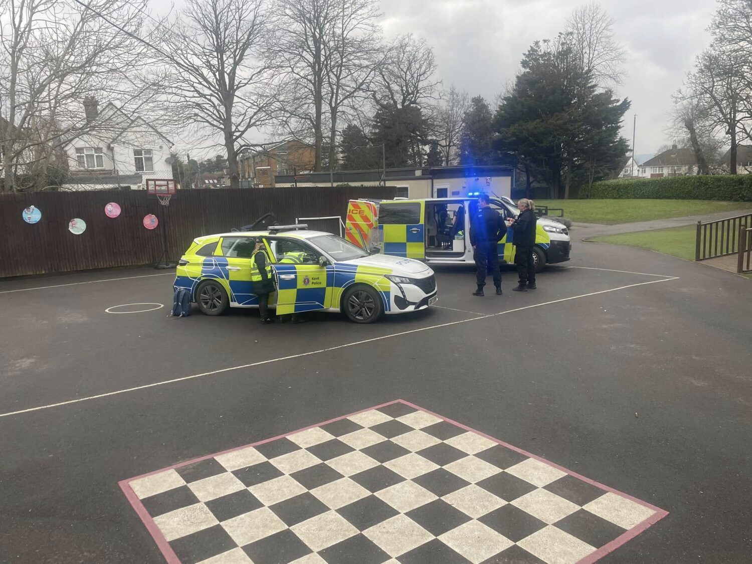 2 police cars parked on the playground