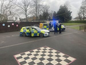 2 police cars parked on the playground